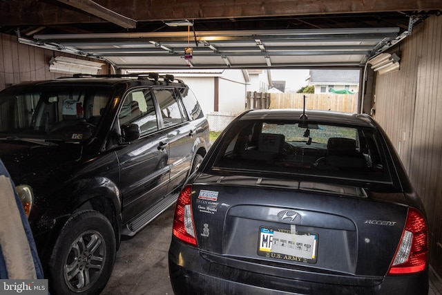 garage featuring wood walls