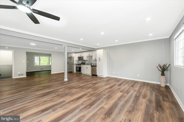 7533 Dover Ln, Lanham, MD 20706 - unfurnished living room featuring dark wood-style floors, ornamental molding, a sink, baseboards, and recessed lighting
