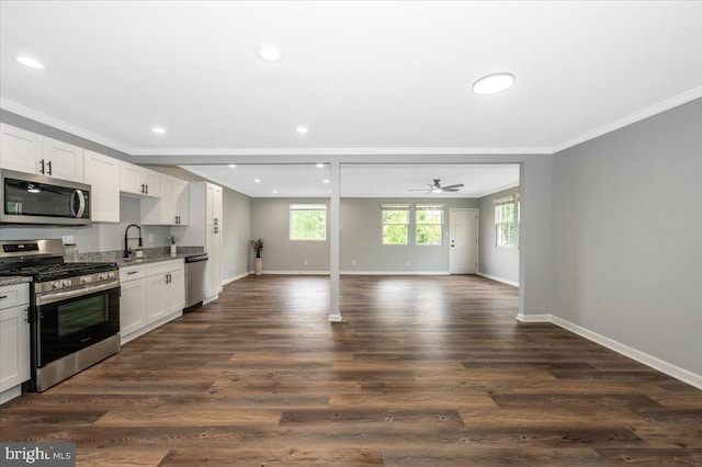 7533 Dover Ln, Lanham, MD 20706 - kitchen with appliances with stainless steel finishes, crown molding, a sink, baseboards, and light stone counters