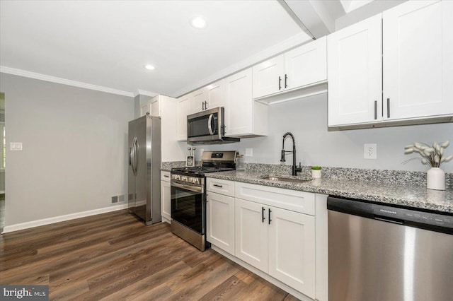 7533 Dover Ln, Lanham, MD 20706 - kitchen with stainless steel appliances, crown molding, white cabinets, dark wood finished floors, and light stone countertops