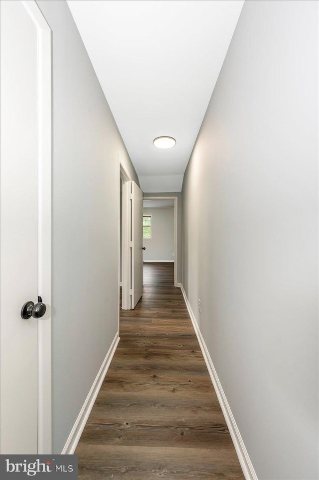 7533 Dover Ln, Lanham, MD 20706 - hallway featuring dark wood-style flooring and baseboards