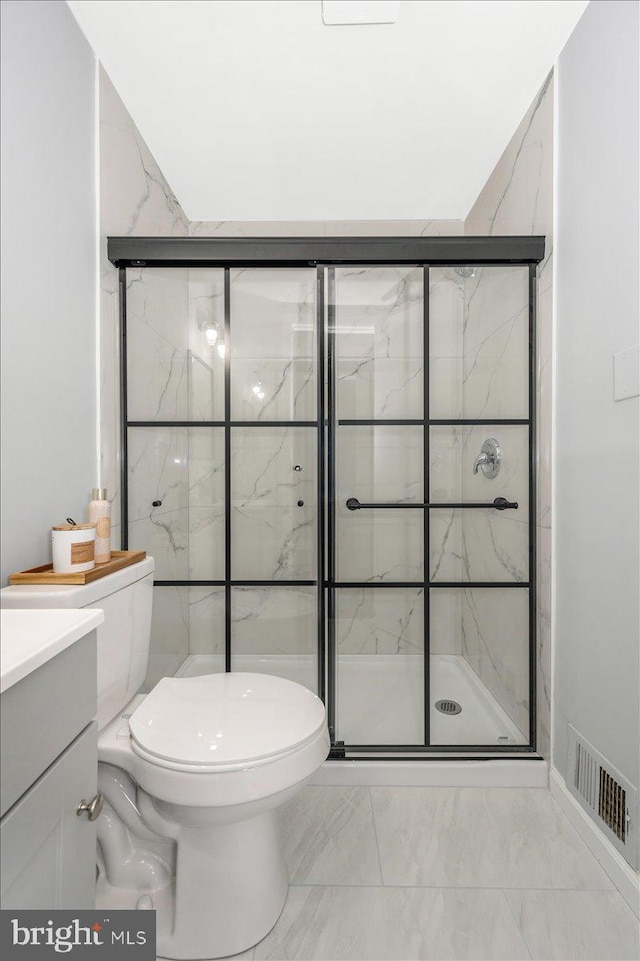 7533 Dover Ln, Lanham, MD 20706 - bathroom featuring marble look tiles, toilet, a marble finish shower, and vanity