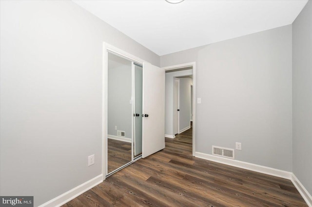 7533 Dover Ln, Lanham, MD 20706 - empty room featuring dark wood-style floors and baseboards