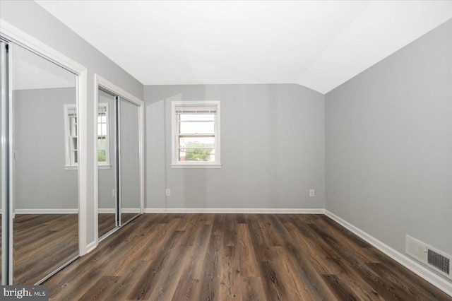 7533 Dover Ln, Lanham, MD 20706 - unfurnished bedroom with dark wood-style flooring, two closets, baseboards, and lofted ceiling