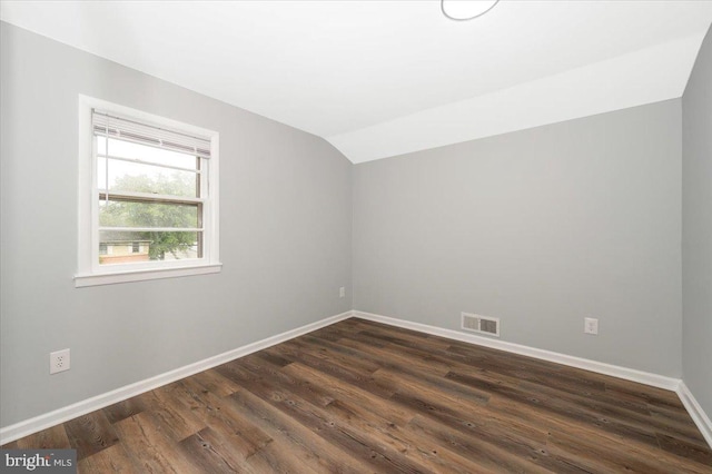 7533 Dover Ln, Lanham, MD 20706 - spare room featuring lofted ceiling, baseboards, and dark wood-style flooring