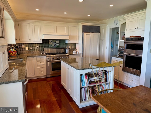 kitchen with white cabinetry, high quality appliances, a sink, and open shelves