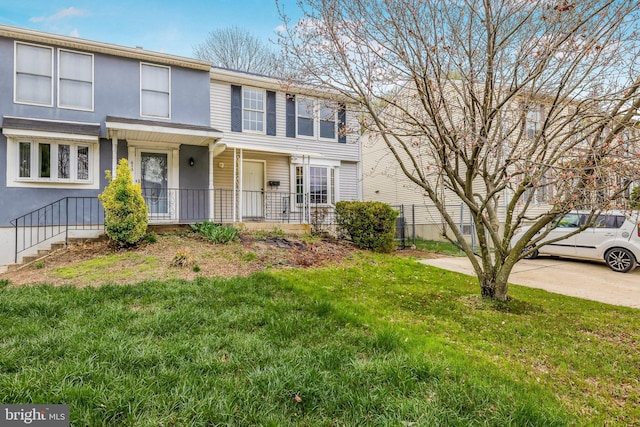 view of front of house with a porch and a front lawn