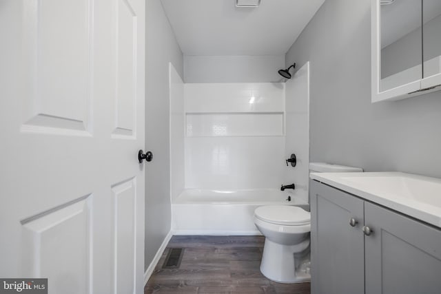 bathroom with vanity, toilet, visible vents, shower / bathing tub combination, and wood finished floors