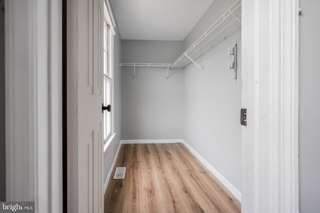 spacious closet with light wood-type flooring and visible vents