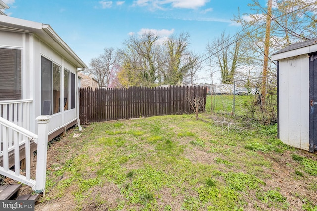 view of yard with a fenced backyard and an outdoor structure