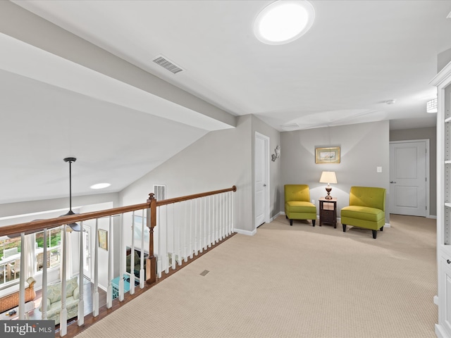 sitting room featuring baseboards, visible vents, light colored carpet, and ceiling fan