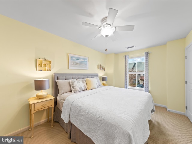 bedroom featuring light carpet, a ceiling fan, visible vents, and baseboards