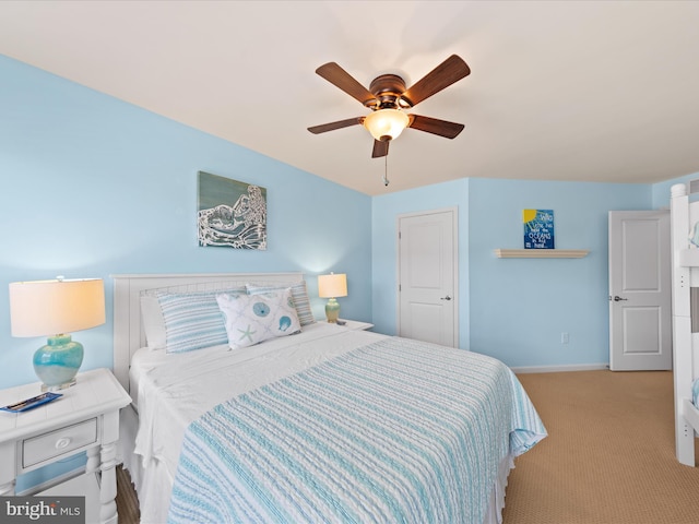 bedroom featuring a ceiling fan, baseboards, and light colored carpet