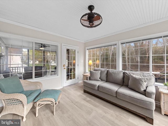 sunroom / solarium featuring plenty of natural light, ceiling fan, and an outdoor hangout area