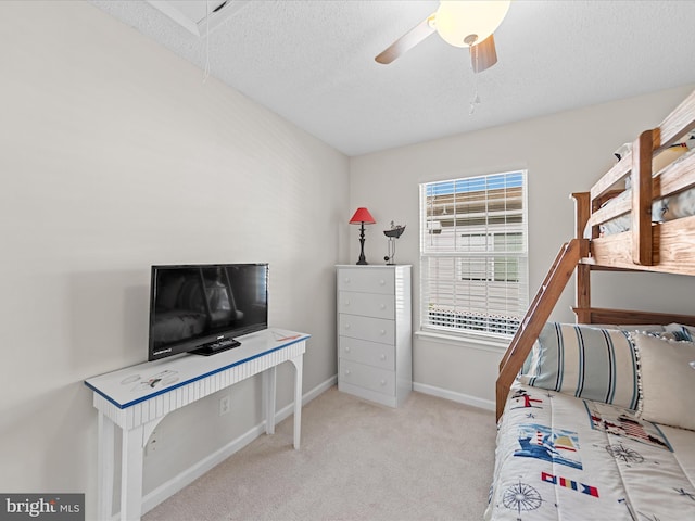 bedroom featuring carpet, a textured ceiling, a ceiling fan, and baseboards
