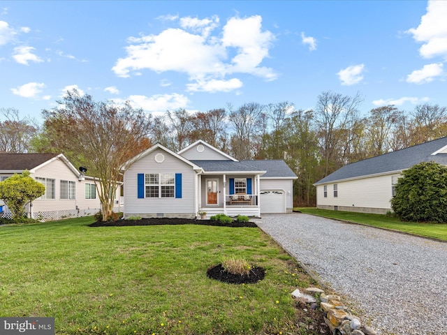 view of front of house featuring an attached garage, driveway, a front lawn, and covered porch