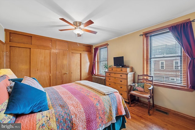 3257 Almond St, Philadelphia, PA 19134 - bedroom featuring light wood-type flooring, baseboards, visible vents, radiator heating unit, and ceiling fan