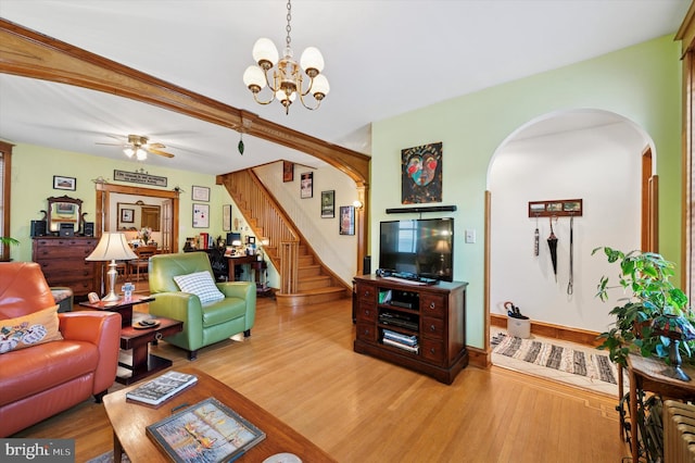 3257 Almond St, Philadelphia, PA 19134 - living room with stairway, arched walkways, wood finished floors, and ceiling fan with notable chandelier