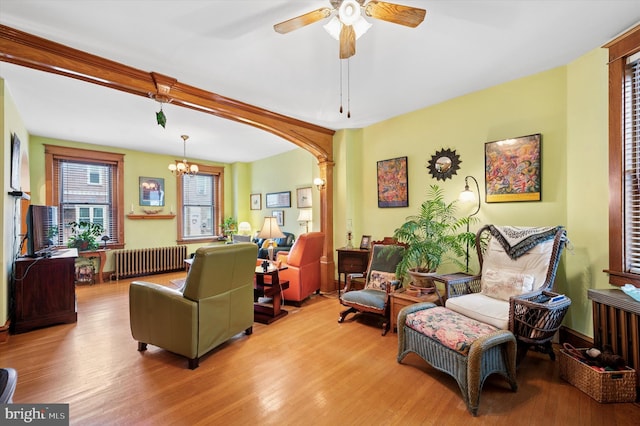3257 Almond St, Philadelphia, PA 19134 - living room with radiator, wood finished floors, and ceiling fan with notable chandelier