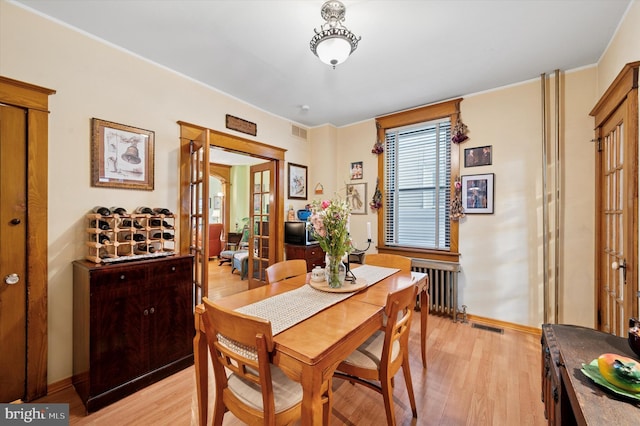3257 Almond St, Philadelphia, PA 19134 - dining space featuring radiator, visible vents, light wood finished floors, and baseboards
