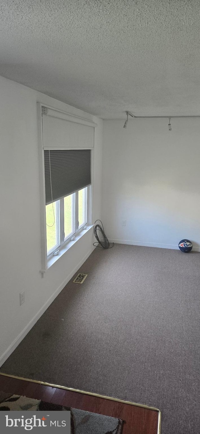 626 Felton Ave, Sharon Hill, PA 19079 - spare room featuring a textured ceiling, carpet floors, visible vents, and baseboards