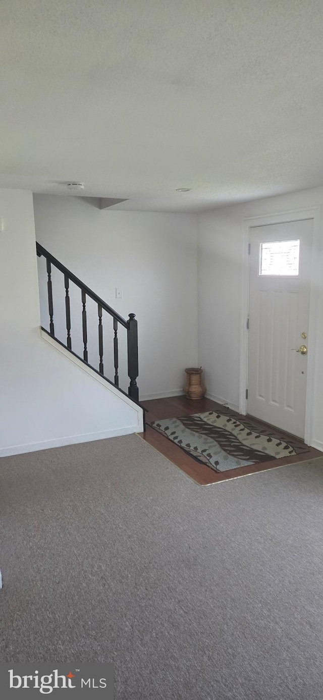 626 Felton Ave, Sharon Hill, PA 19079 - carpeted foyer entrance with stairway, a textured ceiling, and baseboards