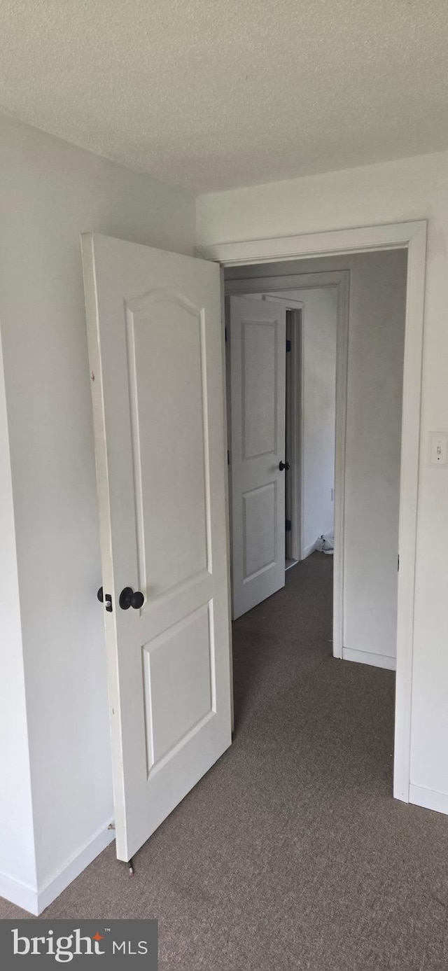 626 Felton Ave, Sharon Hill, PA 19079 - corridor with dark carpet and a textured ceiling