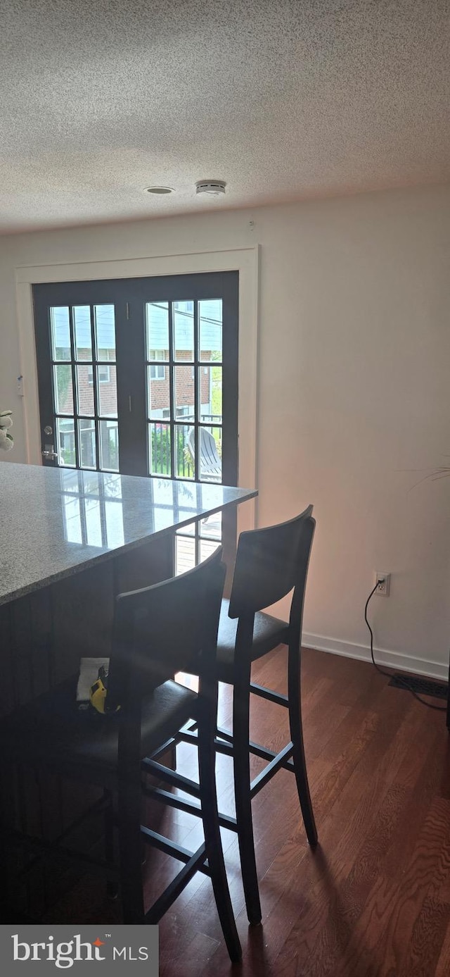 626 Felton Ave, Sharon Hill, PA 19079 - dining space with dark wood finished floors, a textured ceiling, and baseboards