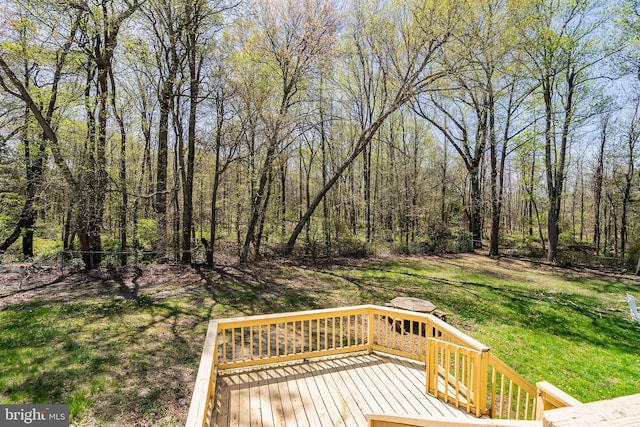 wooden terrace with a lawn