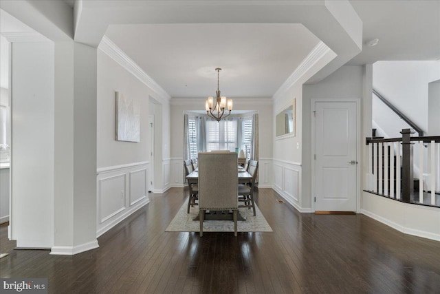 10815 Flying Change Ct, Upper Marlboro, MD 20772 - dining space featuring dark wood-style flooring, wainscoting, an inviting chandelier, a decorative wall, and ornamental molding