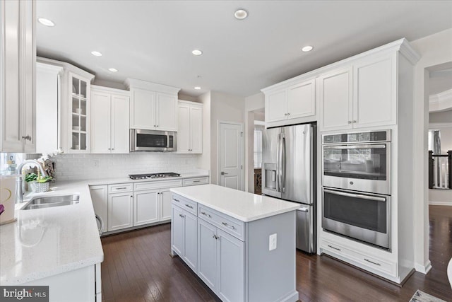 10815 Flying Change Ct, Upper Marlboro, MD 20772 - kitchen featuring a sink, a center island, tasteful backsplash, appliances with stainless steel finishes, and white cabinetry