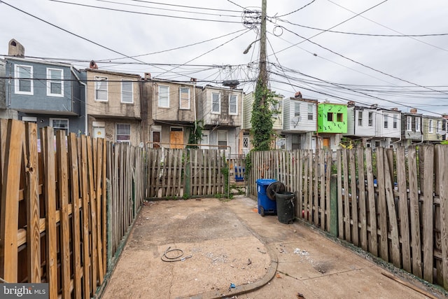 view of patio / terrace with fence and a residential view