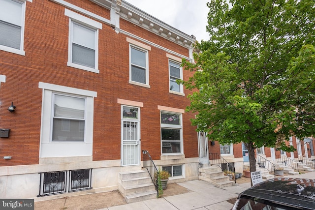 multi unit property featuring brick siding and entry steps