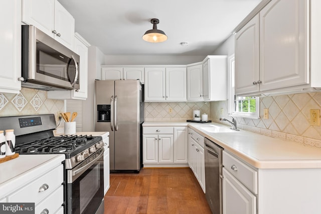 kitchen with white cabinets, tasteful backsplash, and appliances with stainless steel finishes
