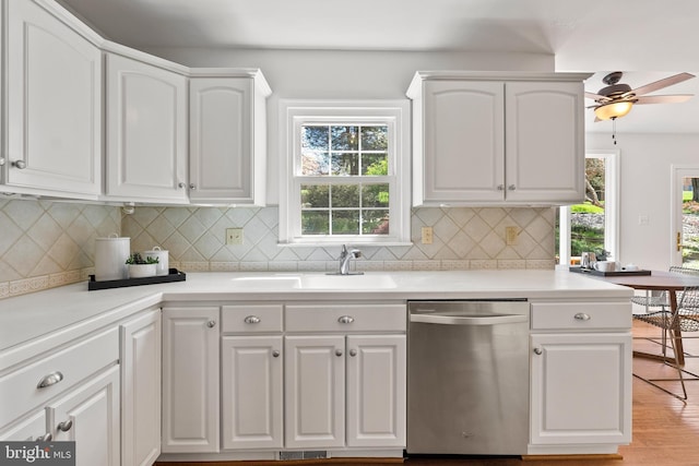 kitchen with dishwasher, white cabinets, a healthy amount of sunlight, and a sink