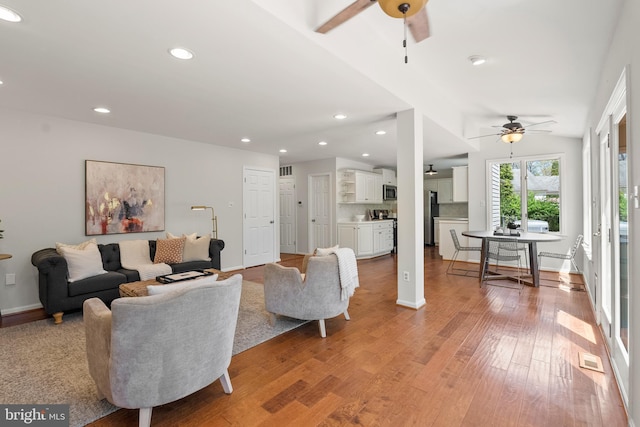 living area with recessed lighting, light wood-type flooring, and a ceiling fan