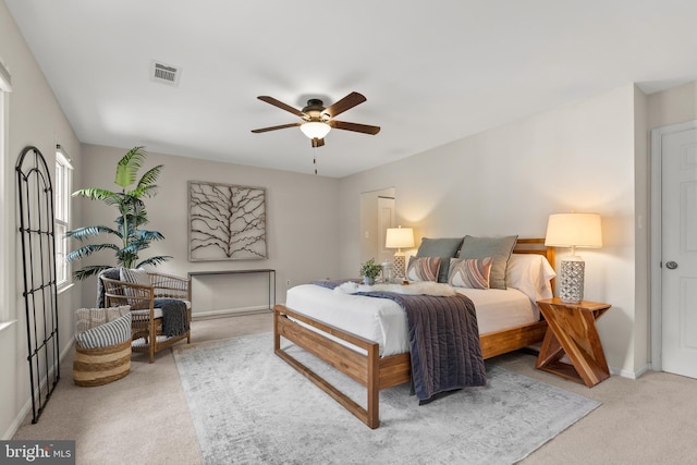 bedroom with visible vents, carpet flooring, baseboards, and ceiling fan