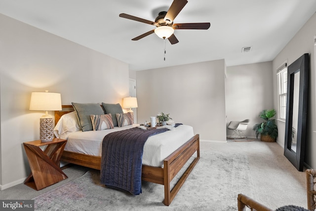 bedroom featuring baseboards, visible vents, carpet flooring, and ceiling fan
