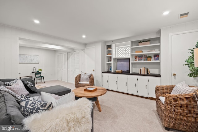 living room featuring light carpet, visible vents, and recessed lighting