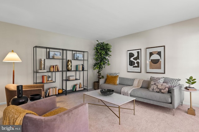 carpeted living area with baseboards
