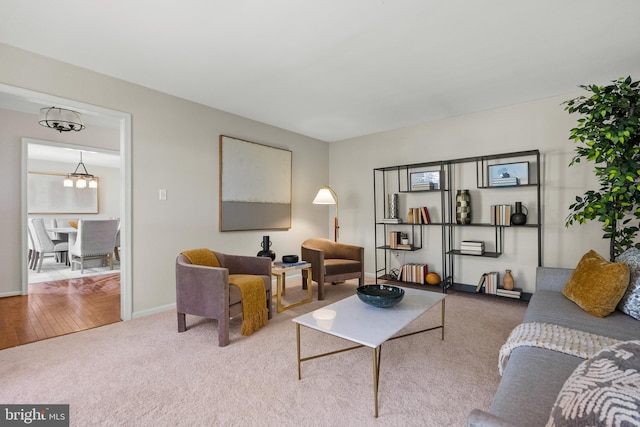 carpeted living room with baseboards