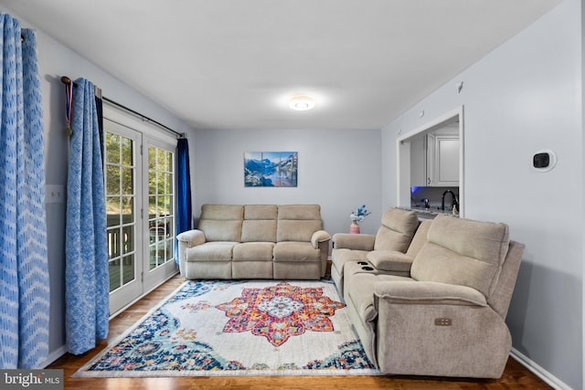 living area featuring wood finished floors and baseboards