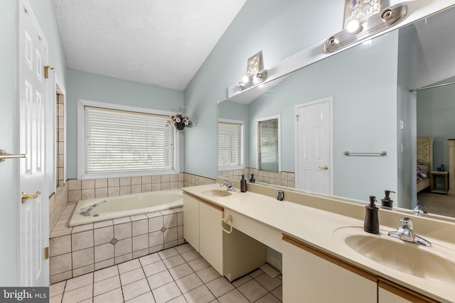 bathroom featuring tile patterned flooring, a bath, a sink, and lofted ceiling