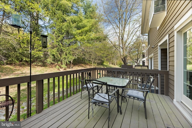 wooden deck featuring outdoor dining space