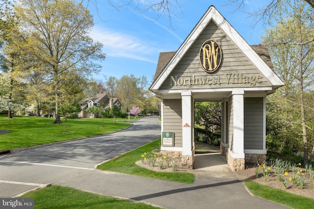 surrounding community featuring driveway and a yard