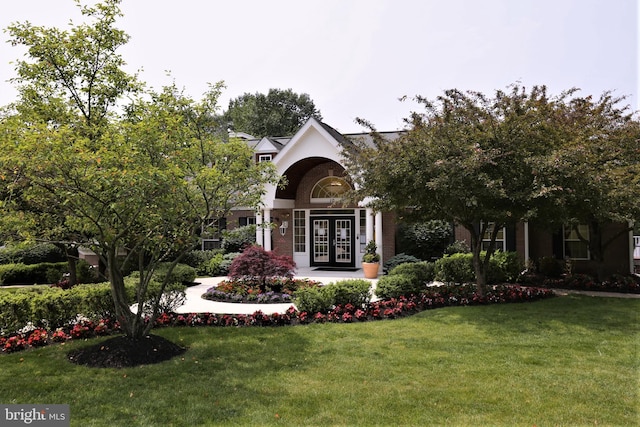 obstructed view of property featuring french doors and a front yard