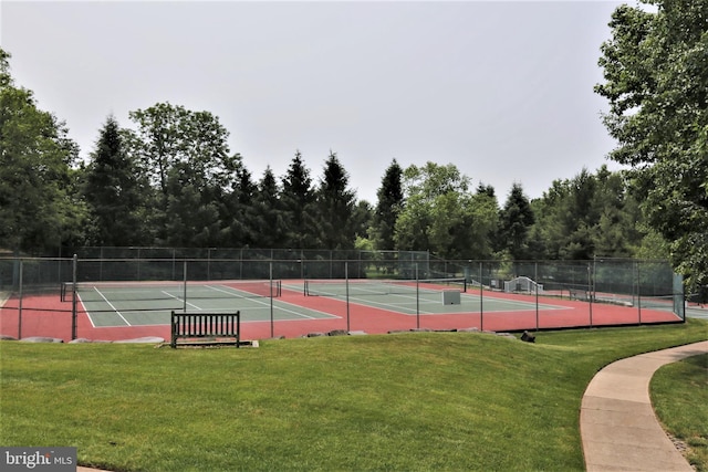 view of sport court featuring fence and a yard