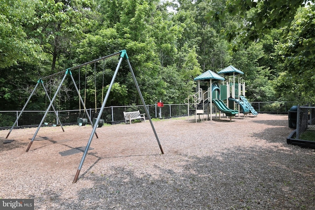 communal playground with a forest view and fence