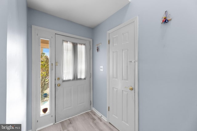 entryway featuring light wood-type flooring and baseboards