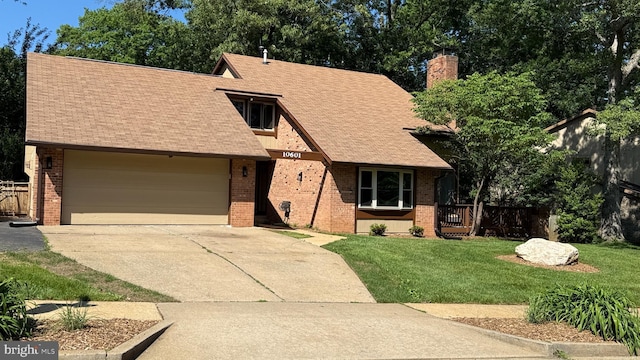 10601 Fiesta Rd, Fairfax, VA 22032 - view of front of house with concrete driveway, brick siding, a garage, a chimney, and roof with shingles